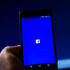facebook logo phone man's hand app
