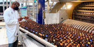 Keroche Production Manager George Otinga inspecting some of the beer bottles at the Naivasha-based factory.