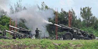 Taiwan military soldiers fire the 155-inch howitzers