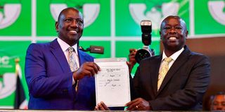 Kenyan President-Elect William Ruto (centre), standing next to his running mate Rigathi Gachaua.