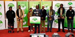 (IEBC) Chairperson Wafula Chebukati (centre) with the agency's commissioners.