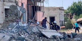 People evacuating from a destroyed residential building after shelling in the town of Voznesensk.