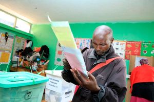 A man prepares to cast his ballots on August 9, 2022