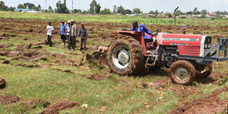 Residents of Njambini-Yamumbi in Eldoret, Uasin Gishu County look on as a tractor ploughs the killer Njambini playground