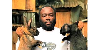 Alee Kagwa Waweru holds different breeds of rabbits