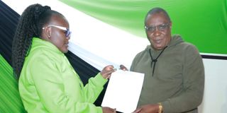 Wiper Party’s Mwalika Mboni receives his certificate from Kitui Rural returning officer Winfred Ndoti.