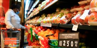 A customer picks fruits at a supermarket in Nyeri.