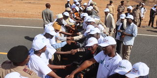 Members of Borana and Gabbra communities hold hands in a call for reconciliation