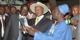 Ugandan President Yoweri Museveni (centre) and former Prime Minister Raila Odinga.