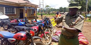 Endebess OCPD Mr Salesio Murrithi verifying a number plate from a stolen motorcycle at Endebess police station