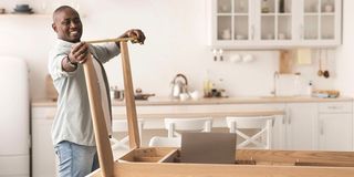 A man measuring a table.