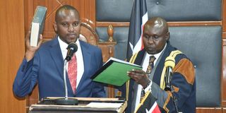 Philip Kipng'etich Muigei (left), is sworn-in as a Speaker of Uasin Gishu County Assembly by assembly Clerk Shadrack Choge
