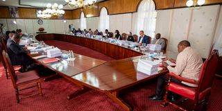 Former President Uhuru Kenyatta (right) chairs a Cabinet meeting at State House.