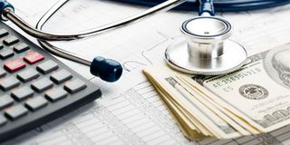 A stethoscope and dollar bills