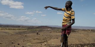 A herder armed with an AK 47 in the Suguta Valley on September 26, 2022 