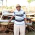 Andrew Githinji inspects the wreckage of his car outside a compound at Gwathamaki village in Nyeri county.