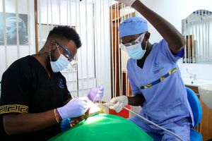 Simon Njoroge (right) assists Dr Peter Jackson Muriuki during a prophylaxis procedure.