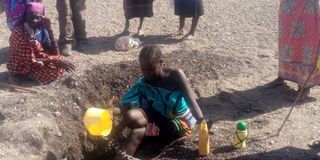 A woman from Atapar village in Turkana North sub-county in search of clean water from a scooping hole 