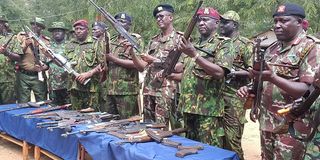 Rift Valley Regional Commissioner Maalim Mohamed (third right) displaying illegal guns recovered in Kerio Valley