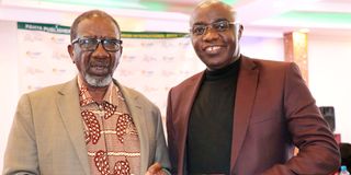 Marx Kahende (left), who won in the Adult English category, with his book The Wayward Vagabond.