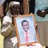 Esther Chirchir, mother of the late William Chepkut, former Ainabkoi MP, family members and other mourners 