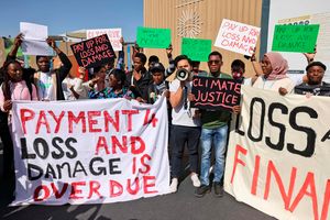Demonstrators hold a protest outside the venue hosting the COP27 climate conference