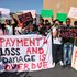 Demonstrators hold a protest outside the venue hosting the COP27 climate conference