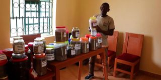 Evans Ochuto with produce from the Vihiga Nutrition and Community Seed bank