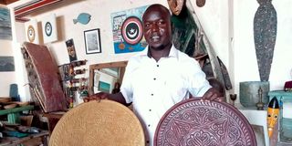 Clement Kiptoon Komen displays his items at his local artist shop in Shella, Lamu.