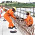 Construction workers fix rebars on the Mwache Bridge. 