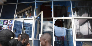Members of the public outside Saito Centre building in Eldoret town, Uasin Gishu County with broken window panes