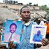 Patrick Karomo’s brother Fredrick Kamau displays the photos of their parents, Peter Njuthi and Faith Wambui