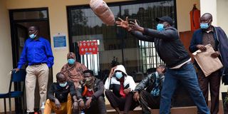 Suspects look on as police officers at DCI head offices along Kiambu road 