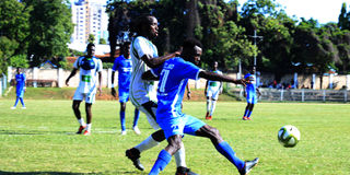 KCB's Michael Mutinda vies with Bandari's Wilberforce Lugogo