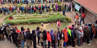 Kenyan voters wait in line to cast their ballots on August 9, 2022.