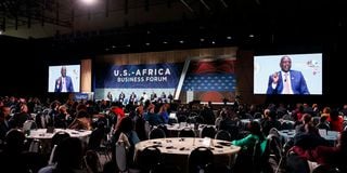 Participants at the US-Africa Leaders Summit watch President William Ruto on huge screens