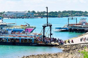 Passengers board MV Harambee as MV Safari arrives at the Likoni crossing
