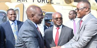 President William Ruto (left) is welcomed to Homa Bay by ICT Cabinet Secretary Eliud Owalo