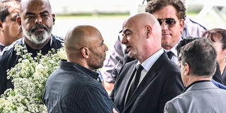 Fifa president Gianni Infantino greets the son of Brazilian football legend Pele, Edinho,