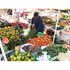 A trader sorts tomatoes at her stand at Chaka market in Nyeri County.