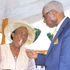 Retired Reverend Canon David Kinyanjui Macharia (right) gives his wife Rosemary Mugure Kinyanjui (left) a cake