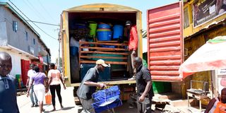 A Vehicle is loaded with household items in Kibera