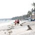 A couple enjoys a walk along the shore of the Indian Ocean on Bamburi Beach on January 24, 2023.