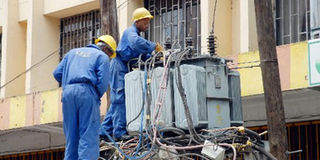 Kenya Power engineers fix a faulty transformer