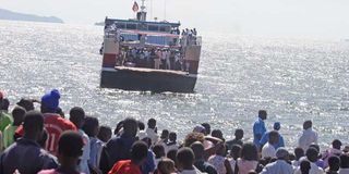 Commuters wait for the arrival of the Mfangano-Mbita ferry in Mbita town