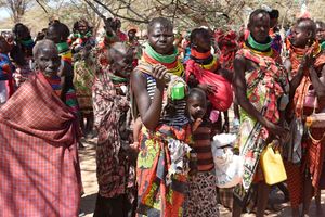 Locals wait for their rations of relief food distribution by President William Ruto