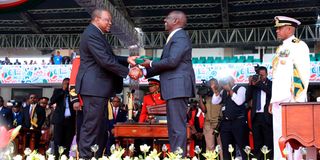 President William Ruto is handed the instruments of power by his predecessor Uhuru Kenyatta.