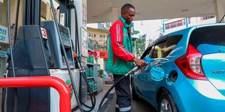 Customer attendant serving a client at Rubis Petroleum Station on Koinange Street, Nairobi