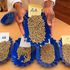 A coffee grader displays various grades of green coffee beans at Kirinyaga County Cooperative Union Laboratory