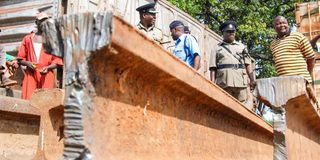 Police officers inspect scrap metal impounded from a smelting firm in Changamwe, Mombasa